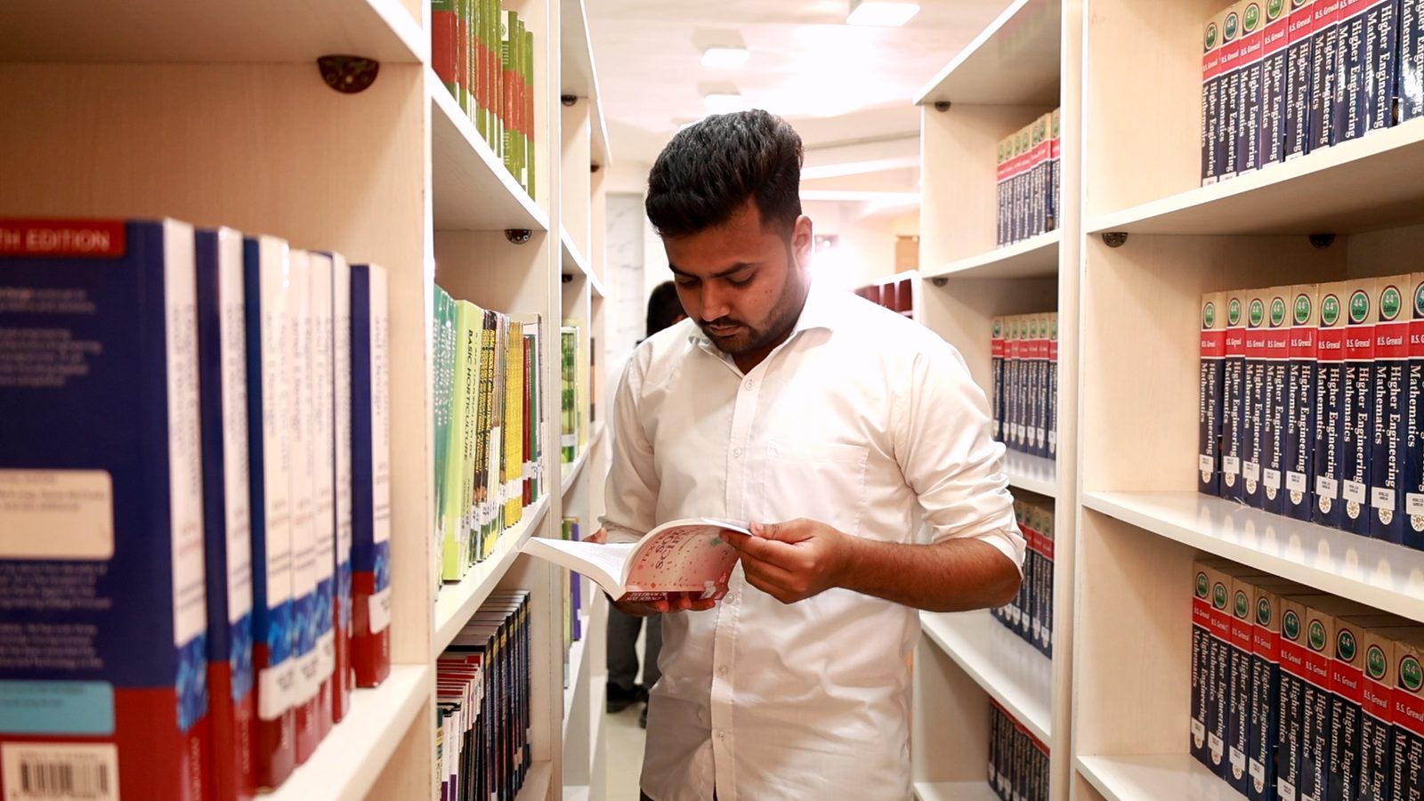 Students at the shelves in the university library