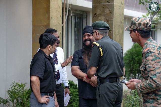 The visiting officer shaking hands with a member of staff outside