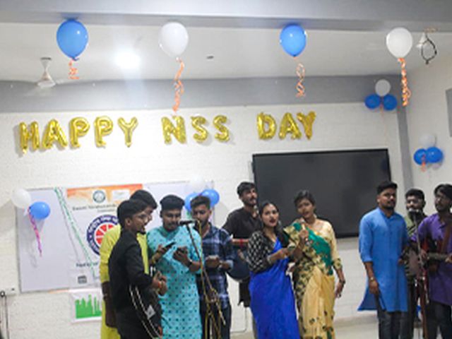 Students gathered under "Happy NSS Day" decorations on campus