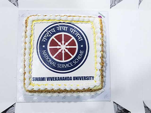 An NSS Day cake iced with the National Service Scheme emblem and the University's name