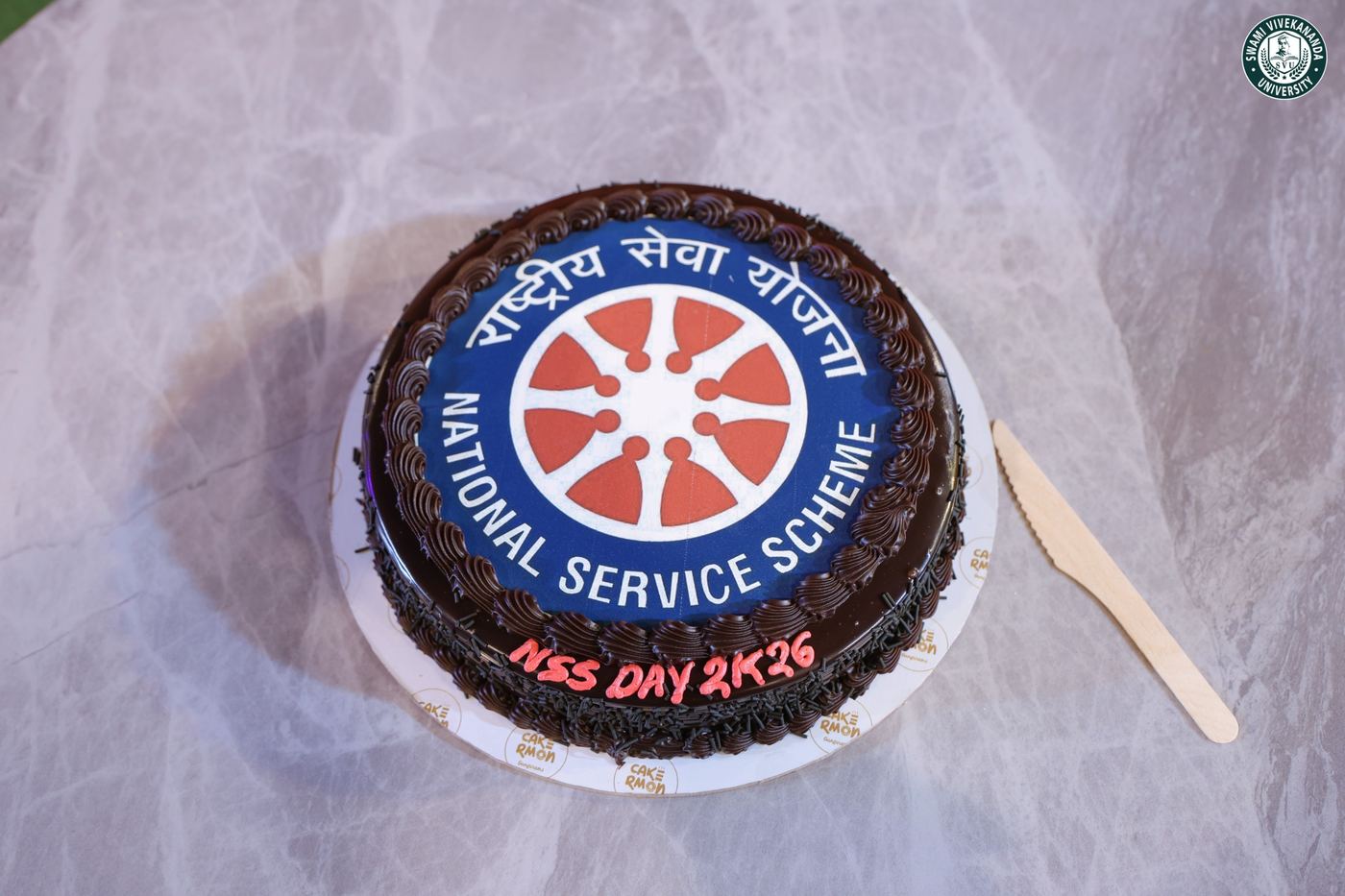 A cake iced with the National Service Scheme emblem, marking NSS Day 2026