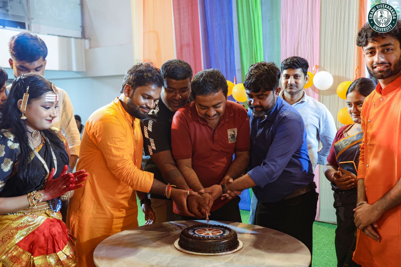 Staff and students gathered round the NSS Day cake
