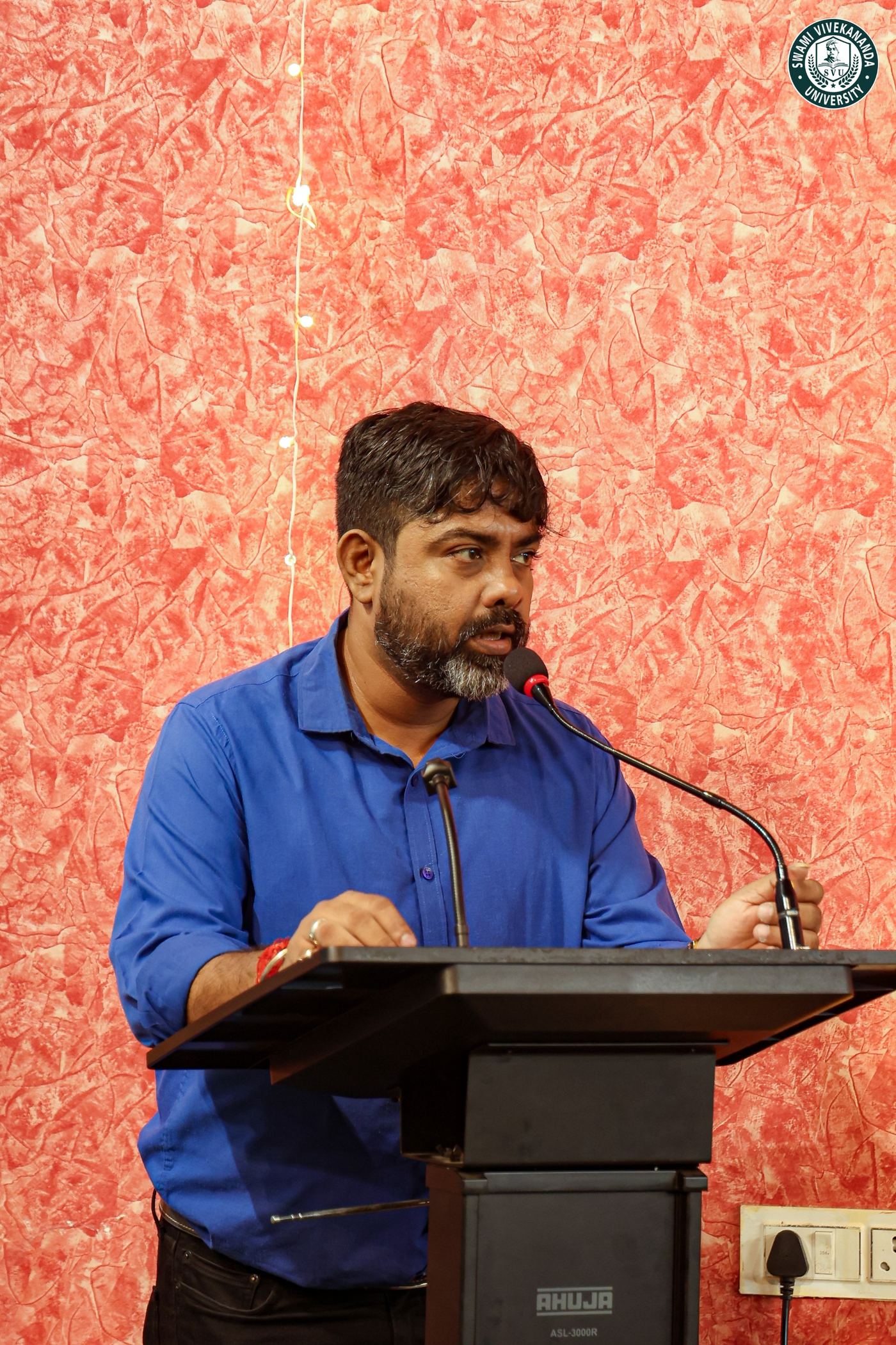 A member of staff addressing the gathering from the lectern