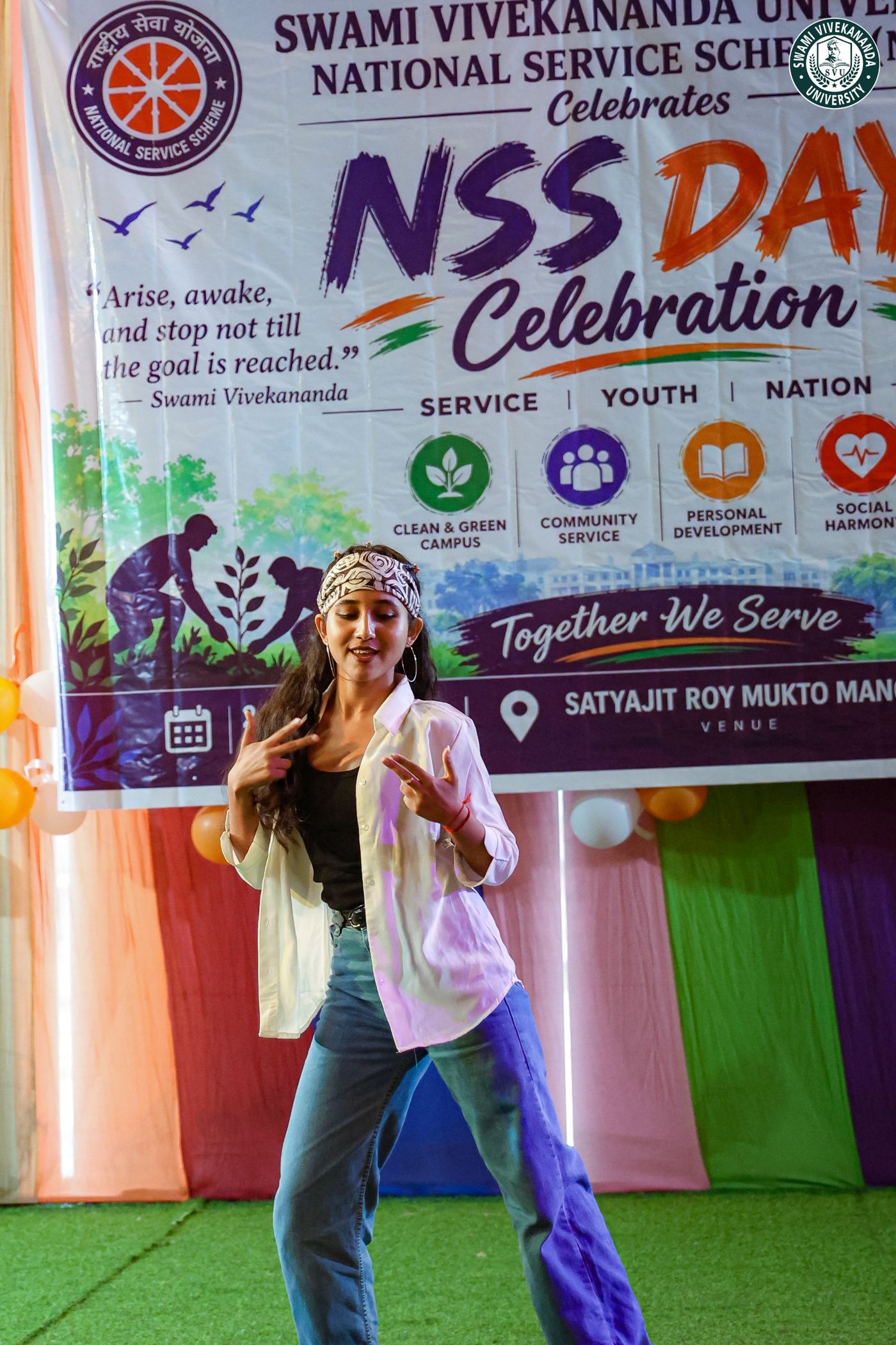 A student performing in front of the NSS Day banner