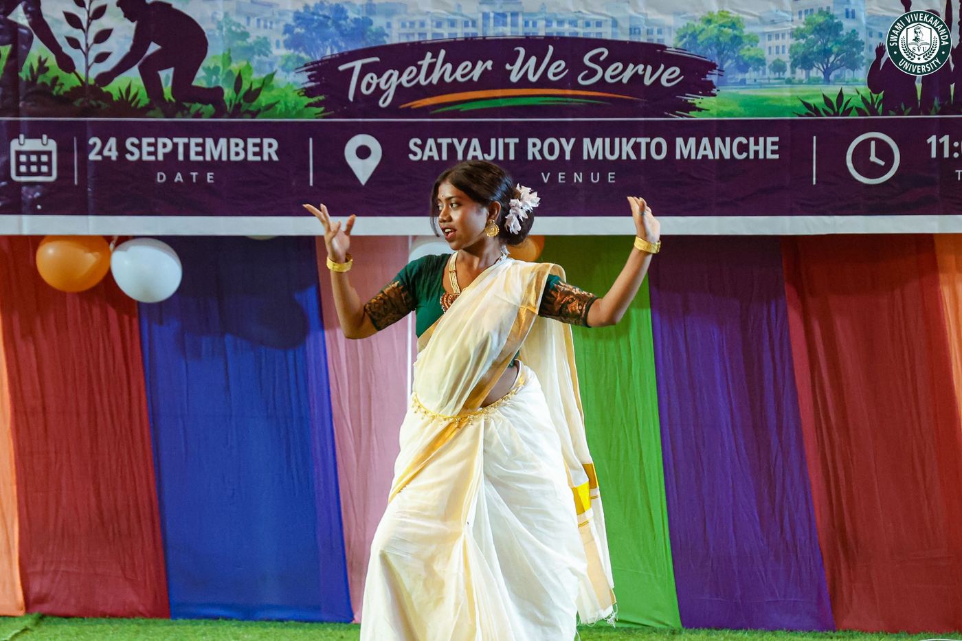 A dancer performing in front of the NSS Day banner