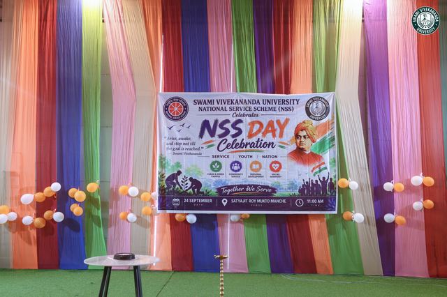 The NSS Day banner on stage, framed by balloons and ribbons
