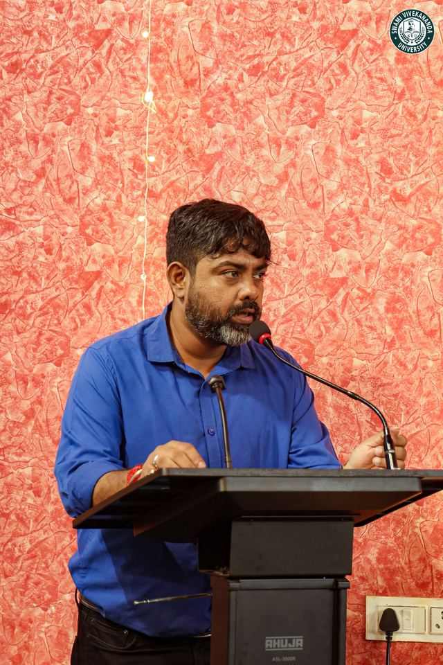A member of staff addressing the gathering from the lectern