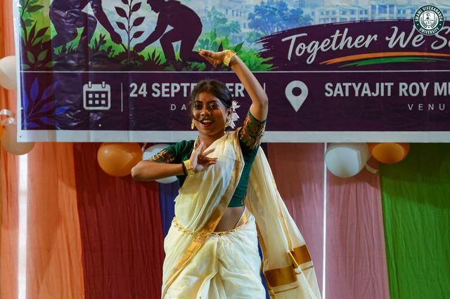 A dancer performing beneath the NSS Day banner