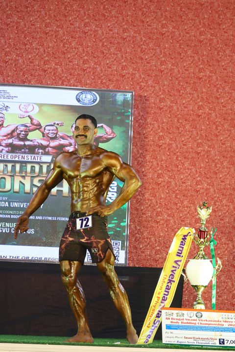 A competitor on stage at the Vivekananda Shree Open State Bodybuilding Championship