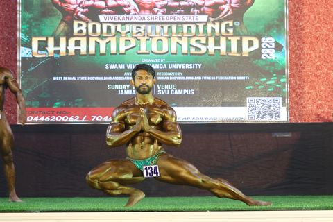 A competitor on stage at the Vivekananda Shree Open State Bodybuilding Championship