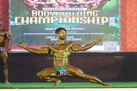 A competitor on stage at the Vivekananda Shree Open State Bodybuilding Championship