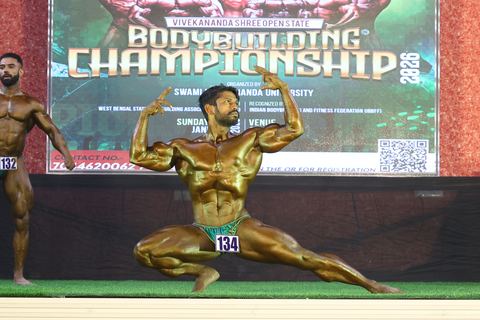 A competitor on stage at the Vivekananda Shree Open State Bodybuilding Championship