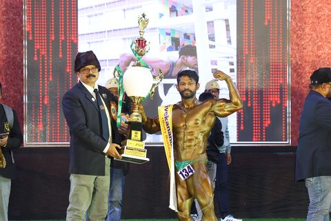 A competitor on stage at the Vivekananda Shree Open State Bodybuilding Championship