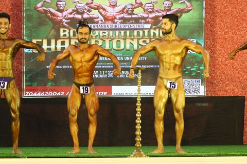 A competitor on stage at the Vivekananda Shree Open State Bodybuilding Championship