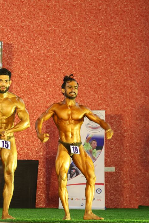 A competitor on stage at the Vivekananda Shree Open State Bodybuilding Championship