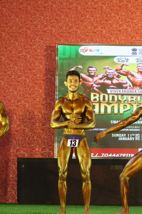 A competitor on stage at the Vivekananda Shree Open State Bodybuilding Championship