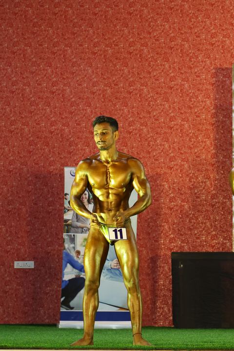 A competitor on stage at the Vivekananda Shree Open State Bodybuilding Championship