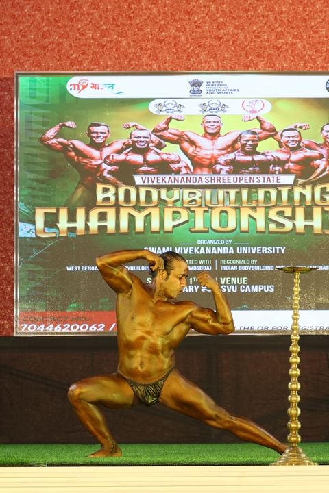 A competitor on stage at the Vivekananda Shree Open State Bodybuilding Championship