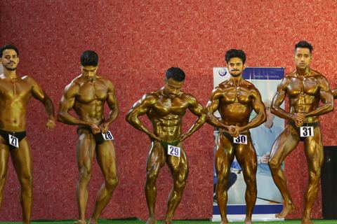 A competitor on stage at the Vivekananda Shree Open State Bodybuilding Championship
