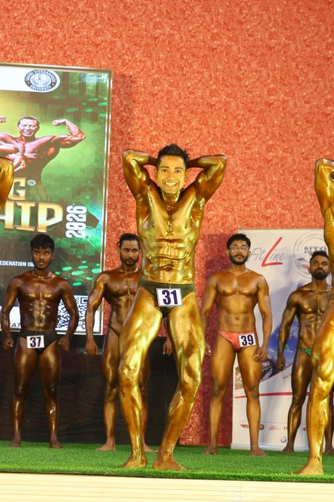 A competitor on stage at the Vivekananda Shree Open State Bodybuilding Championship