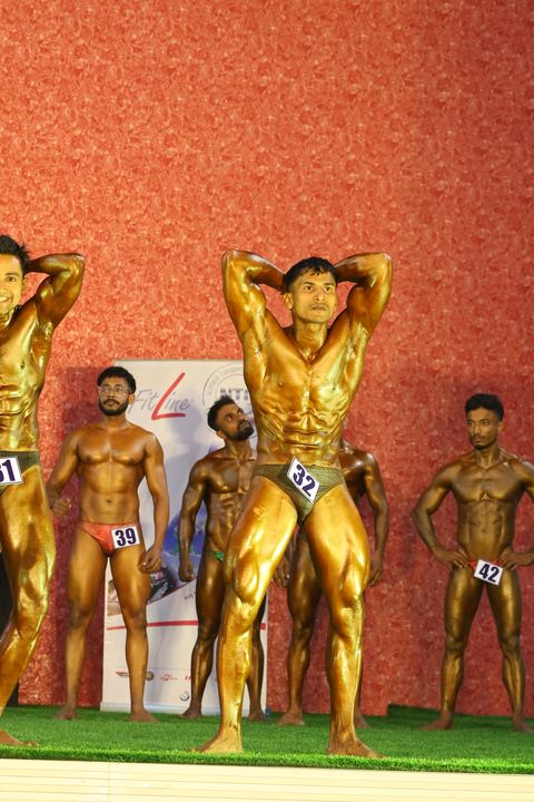 A competitor on stage at the Vivekananda Shree Open State Bodybuilding Championship