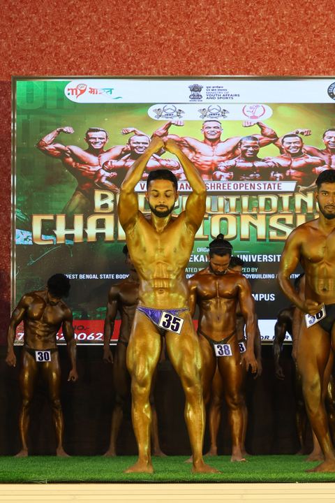 A competitor on stage at the Vivekananda Shree Open State Bodybuilding Championship