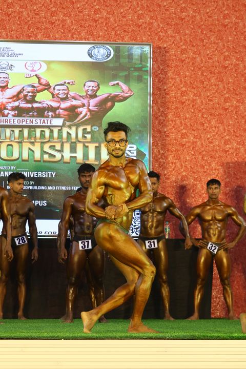A competitor on stage at the Vivekananda Shree Open State Bodybuilding Championship