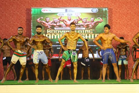 A competitor on stage at the Vivekananda Shree Open State Bodybuilding Championship